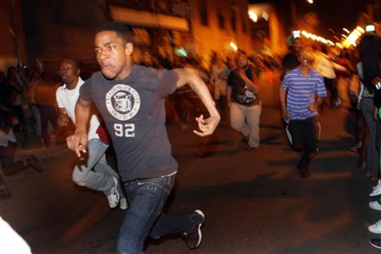 Young people run down South Street during a flash mob incident that involved thousands and closed streets to traffic in Philadelphia on March 20, 2010. 